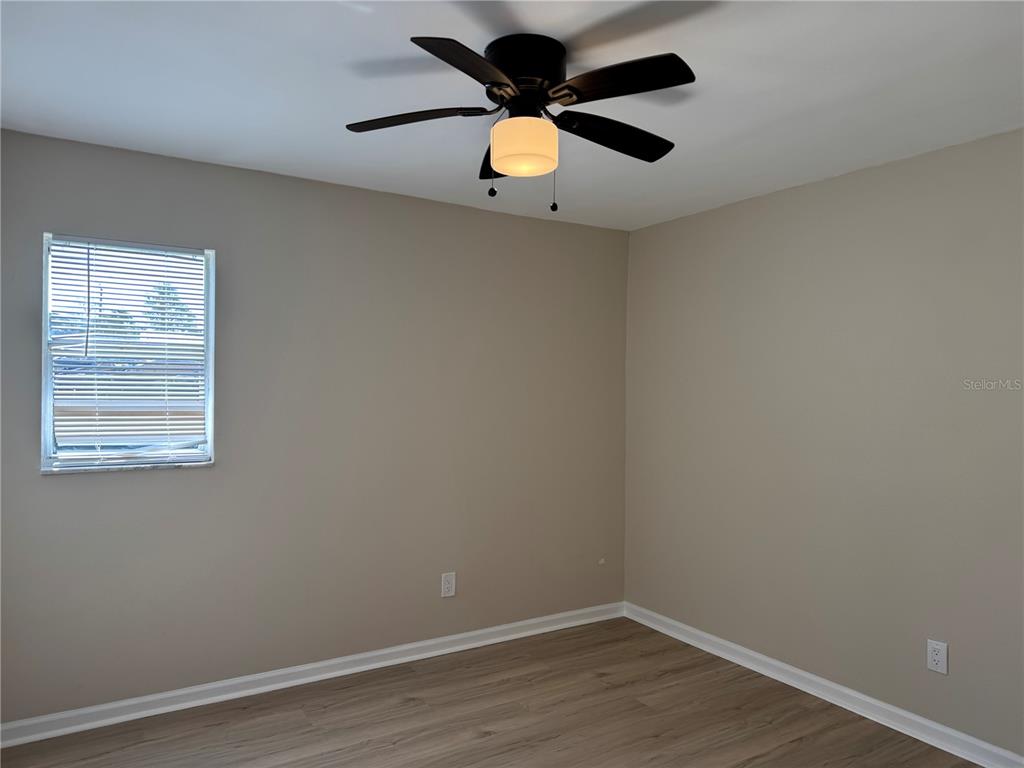 5521 Bay Boulevard, Unit 105 Port Richey, FL 34668 - Photo 12 of 15 an empty room with a window and a ceiling fan