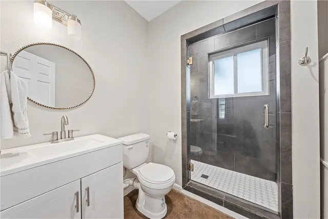 a bathroom with a sink a vanity a mirror and a bathtub next to a window