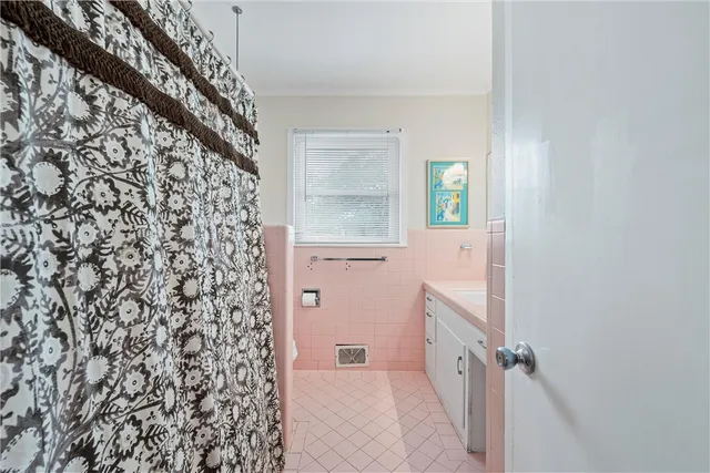 a bedroom with two beds and a dresser