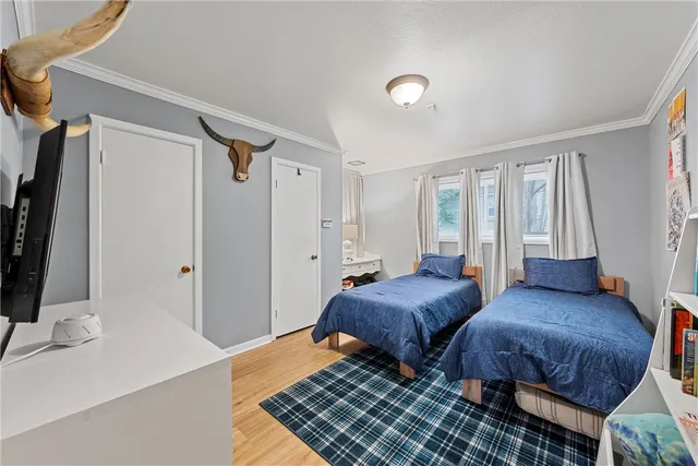 a bedroom with a large bed and a flat screen tv