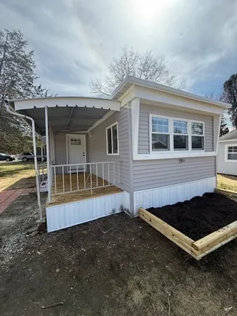 a view of a house with backyard and deck