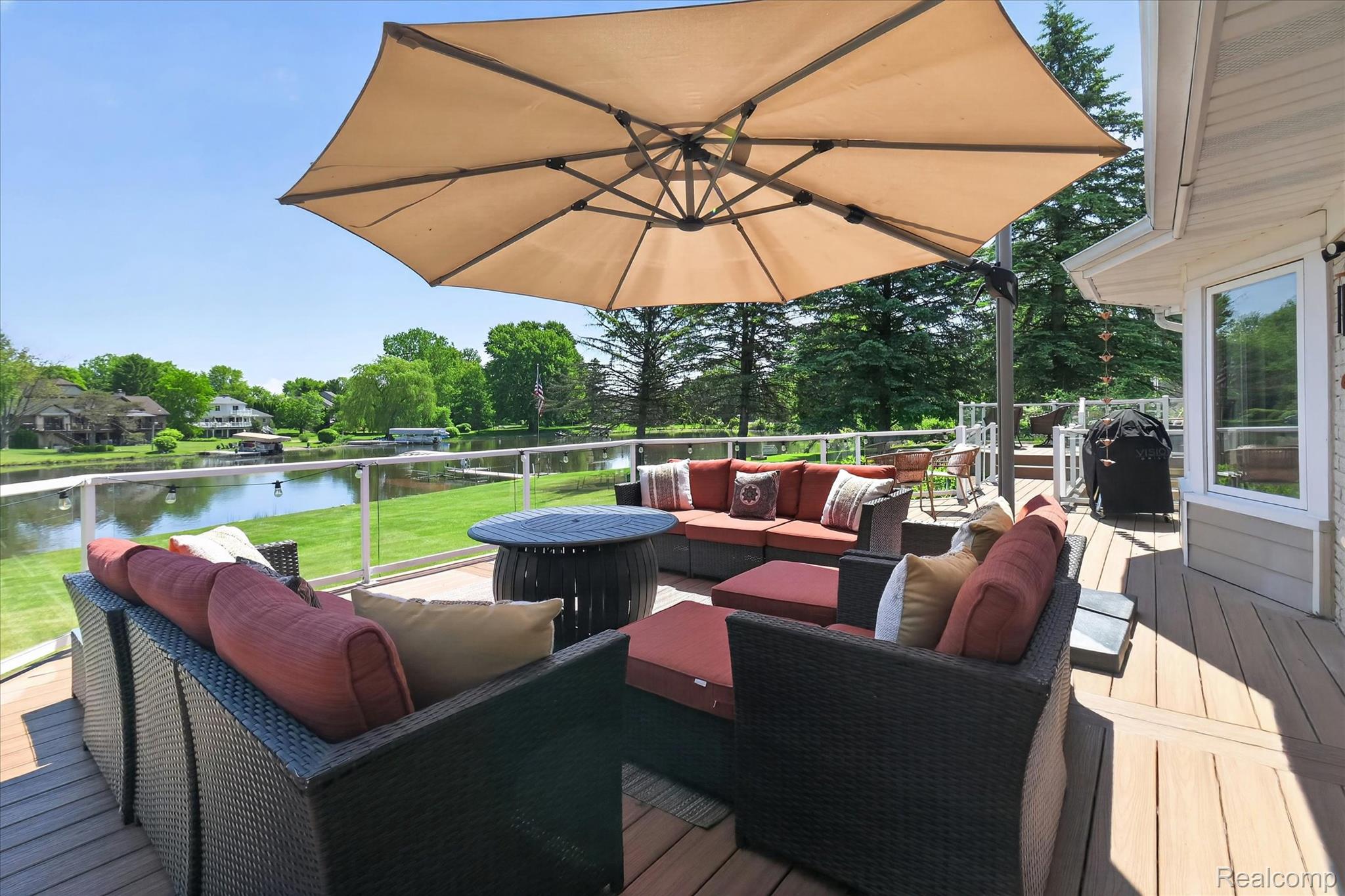 3860 East Commerce Road Commerce Township, MI 48382 - Photo 48 of 72 Expansive outdoor deck featuring composite decking and glass panel railings