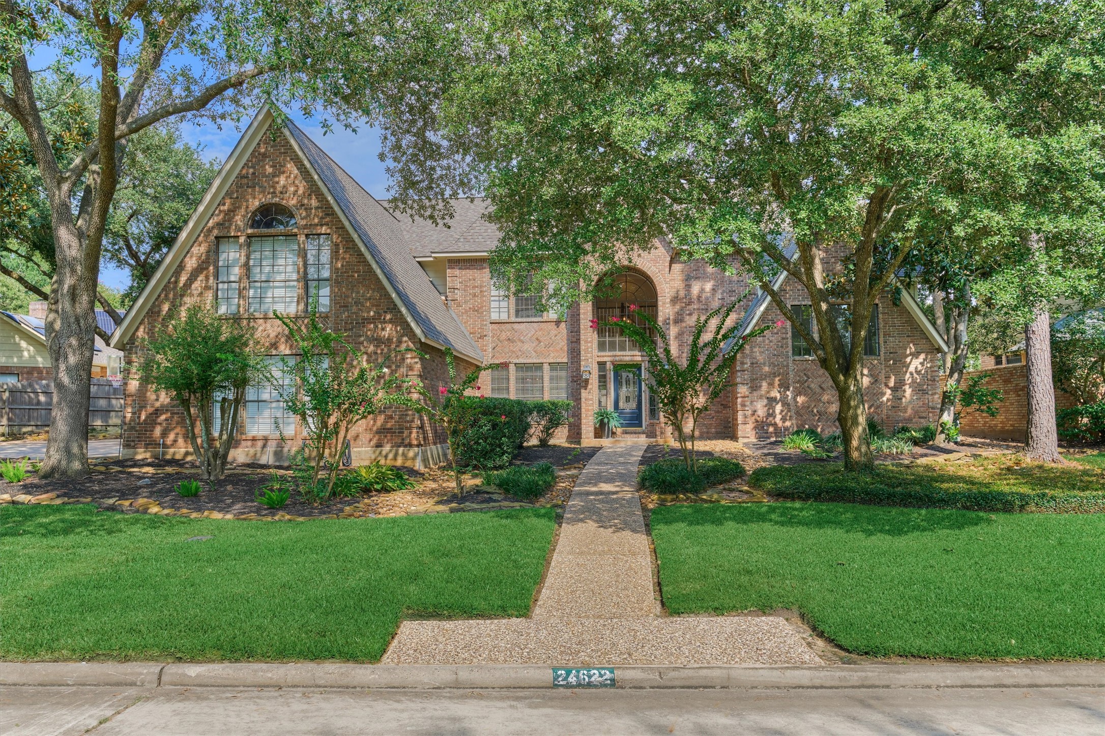 a front view of house with yard and green space