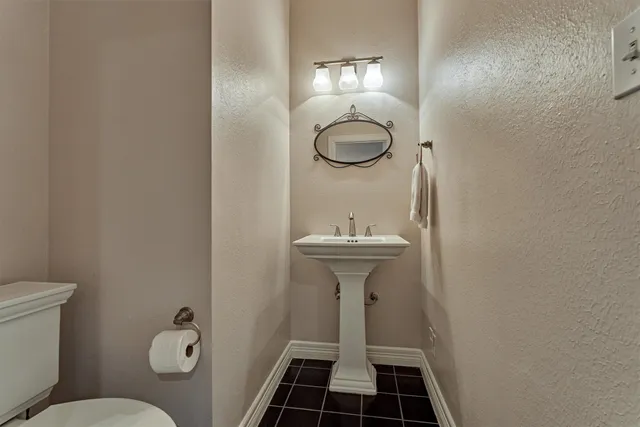 a bathroom with a sink toilet and a mirror
