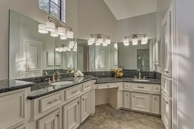 a bathroom with double sink and a mirror