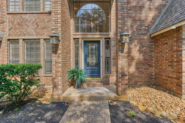 a view of a brick house with a large windows