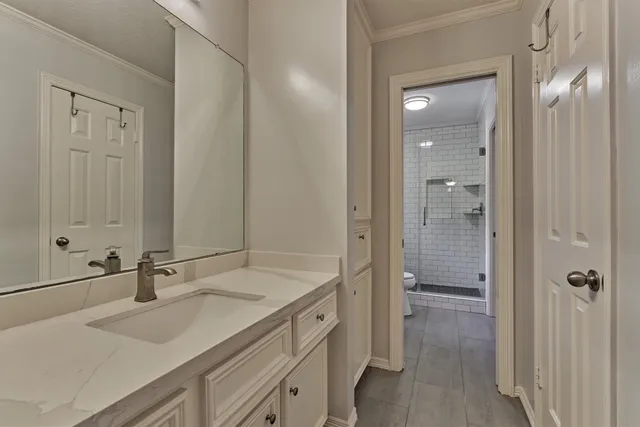 a spacious bathroom with a shower sink and mirror