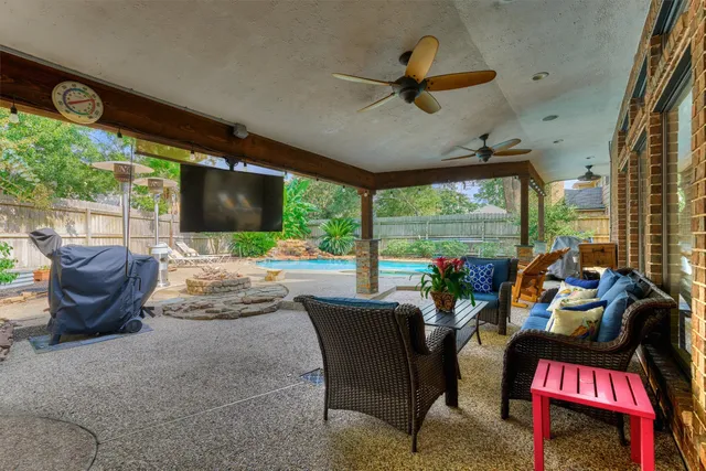 a view of a porch with furniture and a yard