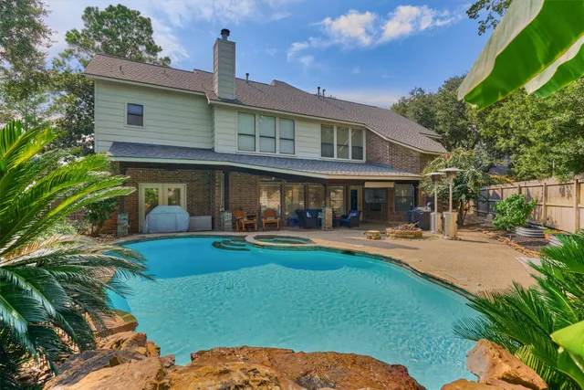 a front view of a house with swimming pool having outdoor seating