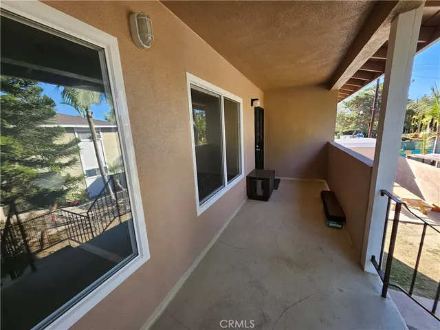 a view of a balcony with chair and front door