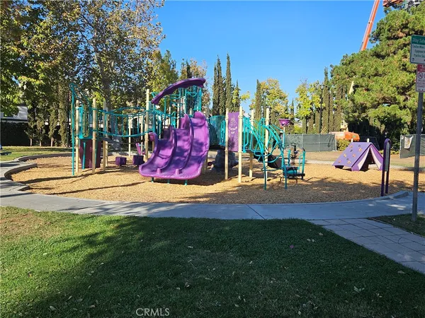 a view of a park with swings and slides