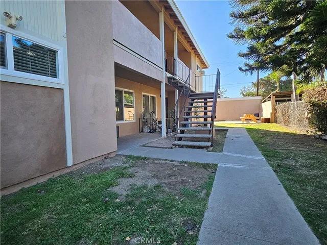 a view of a patio with table and chairs and potted plants