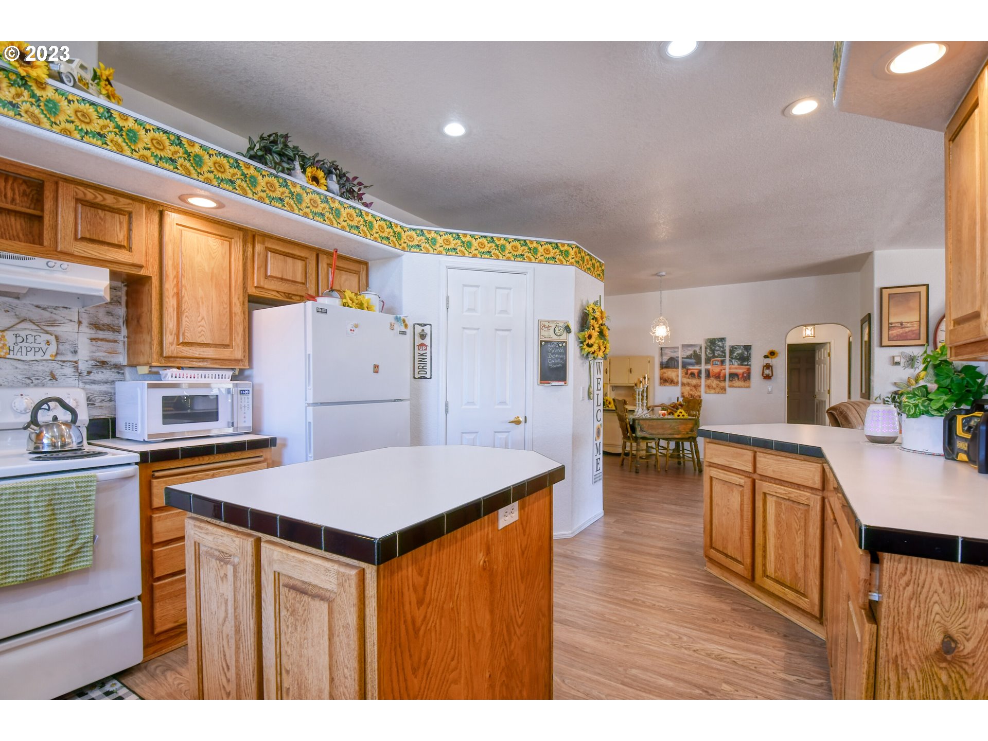 618 Northwest 6th Street Pendleton, OR 97801 - Photo 18 of 41 a kitchen with stainless steel appliances granite countertop a table chairs and a refrigerator
