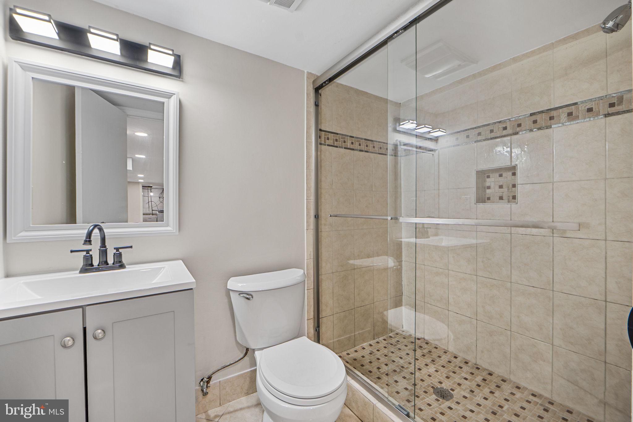 1513 Flora Lane Silver Spring, MD 20910 - Photo 32 of 49 a bathroom with a toilet a sink a shower and a mirror