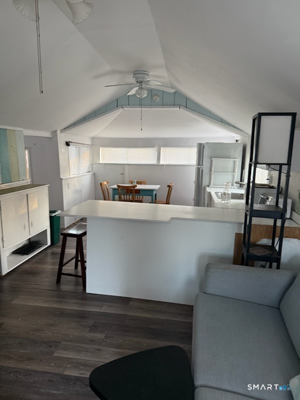 15 North Street Madison, CT 06443 - Photo 3 of 13 a living room with a couch and a dining table