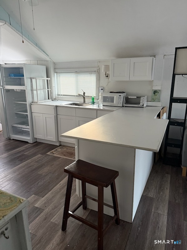 15 North Street Madison, CT 06443 - Photo 4 of 13 a open kitchen with white cabinets a sink dishwasher and a stove with wooden floor
