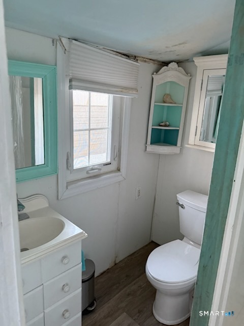 15 North Street Madison, CT 06443 - Photo 10 of 13 a white toilet sitting next to a bathroom sink