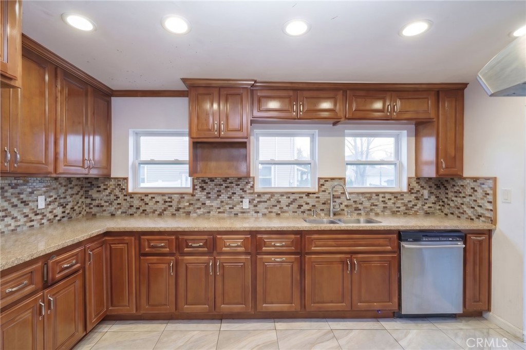 346 West School Street Compton, CA 90220 - Photo 15 of 29 a kitchen with stainless steel appliances granite countertop wooden cabinets and a sink