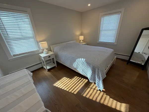 a bed sitting in a bedroom next to a window