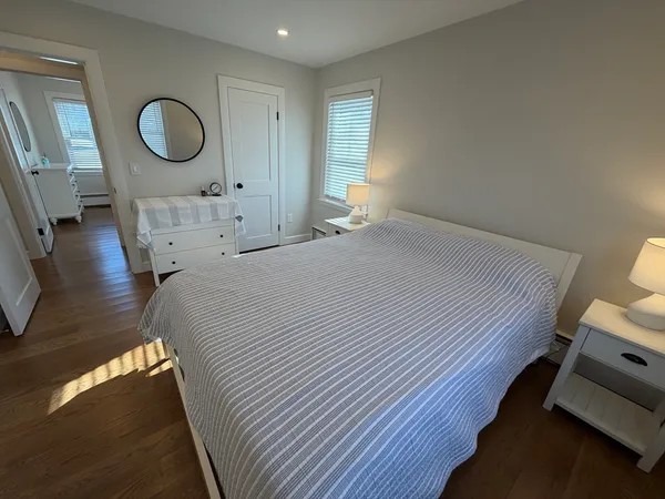 a bedroom with a bed and a mirror