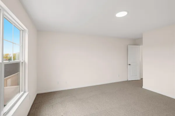 a view of an empty room and a window