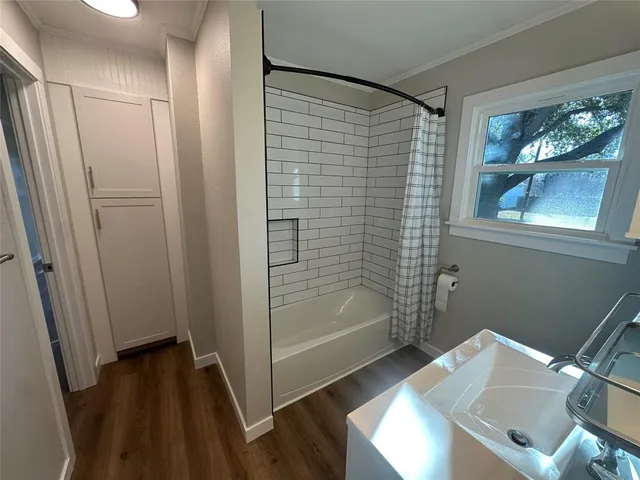 a bathroom with a shower and a sink