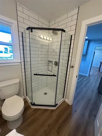 a bathroom with a toilet and shower