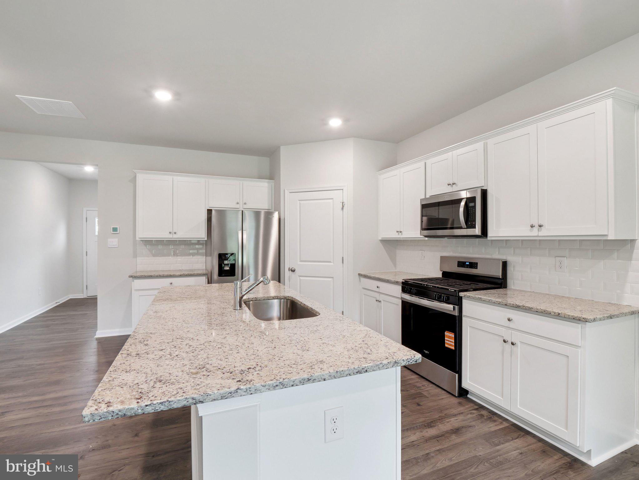 6262 Sterling Way Ruther Glen, VA 22546 - Photo 2 of 31 a kitchen with stainless steel appliances granite countertop a sink stove and refrigerator