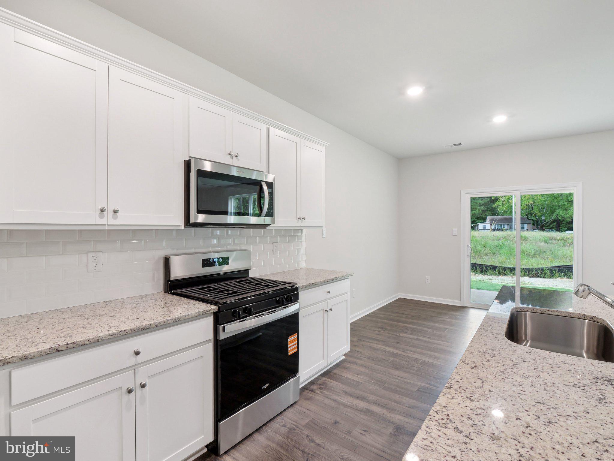 6262 Sterling Way Ruther Glen, VA 22546 - Photo 4 of 31 a kitchen with granite countertop a stove a sink and a granite counter tops