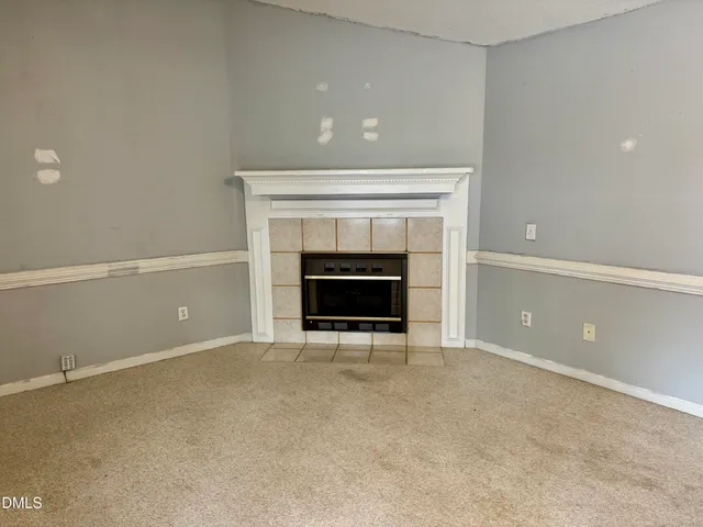 an empty room with a fireplace