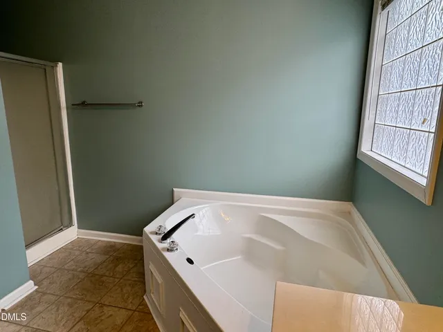 a bathroom with a tub and a window