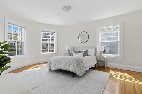 a bedroom with a bed lamp and window