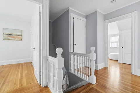 a view of a room with wooden floor and windows