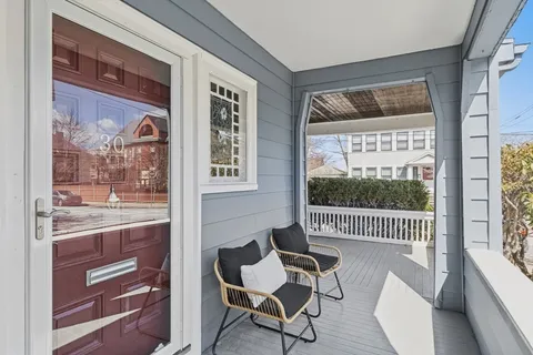 a dining room with wooden floor and a glass door