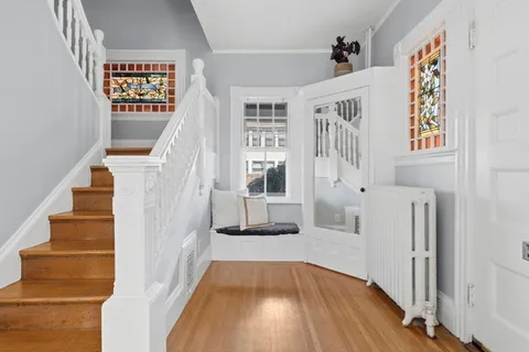 a view of an entryway with wooden floor and door