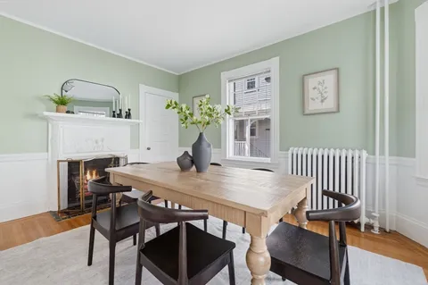 a view of a dining room with furniture and a potted plant