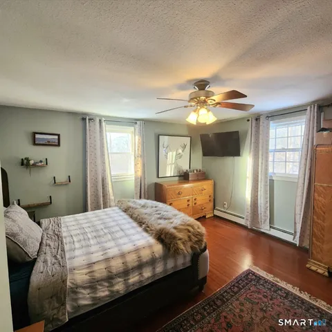 a bedroom with a large bed and a chandelier