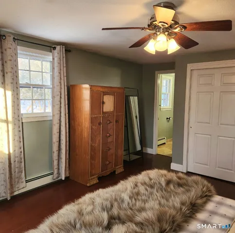 a view of a livingroom with a chandelier fan and a window