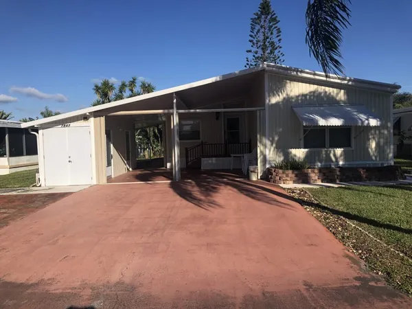 a view of a house with a yard and garage