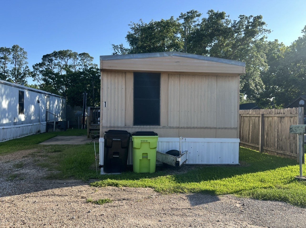 1511-1 Jones Street, Unit 1 Rosenberg, TX 77471 - Photo 1 of 13 a front view of a house with a yard