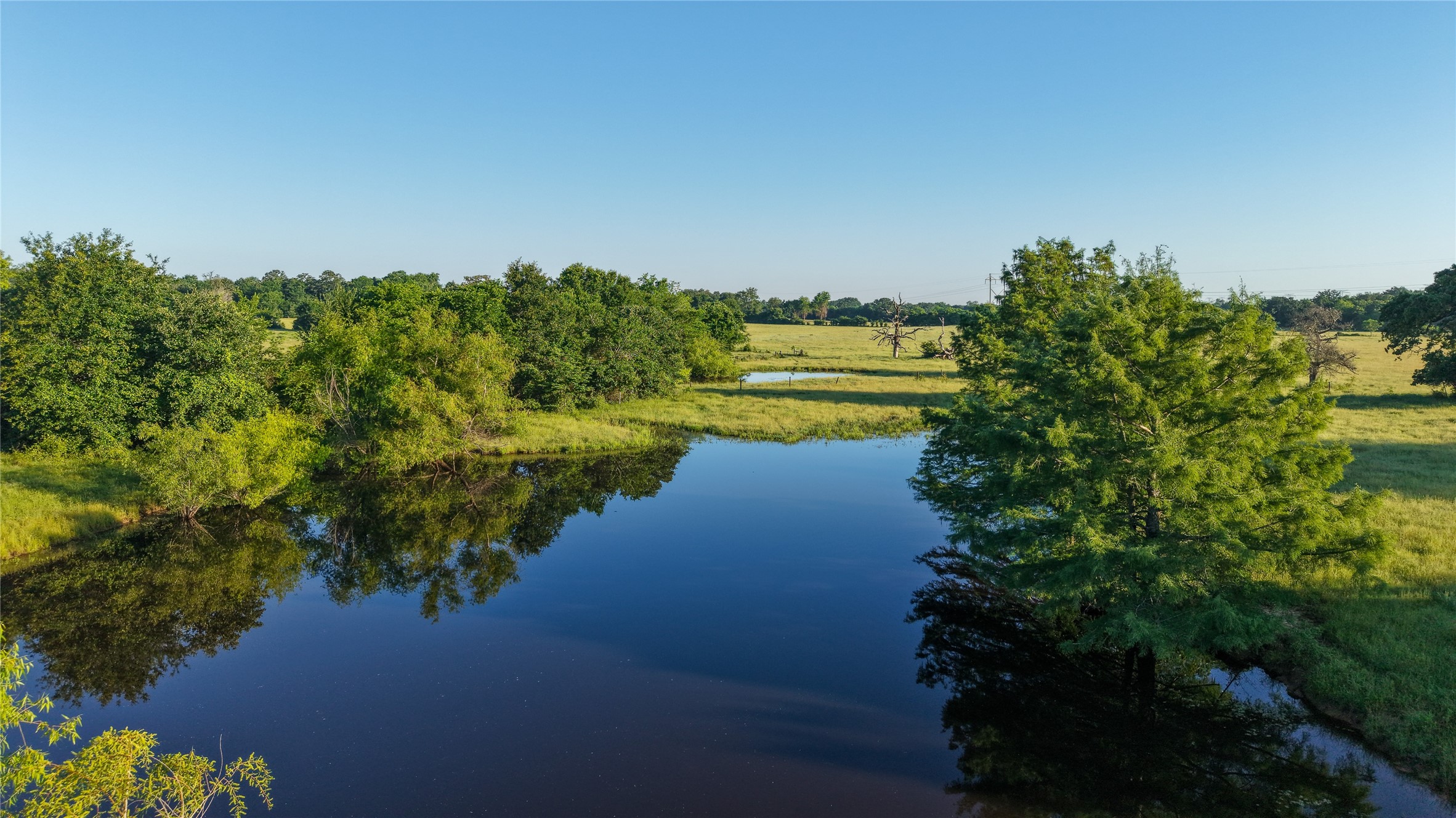 3765 Poteet Road Normangee, TX 77871 - Photo 3 of 37 a view of a lake with a yard