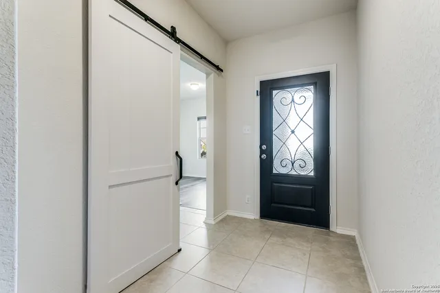 a view of a bathroom from a corridor