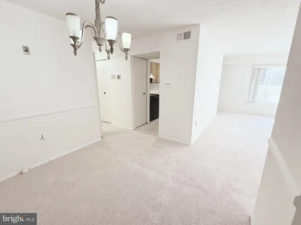 a view of a chandelier fan and refrigerator in a kitchen