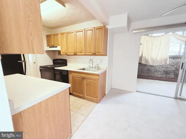 a kitchen with a stove a sink and a refrigerator