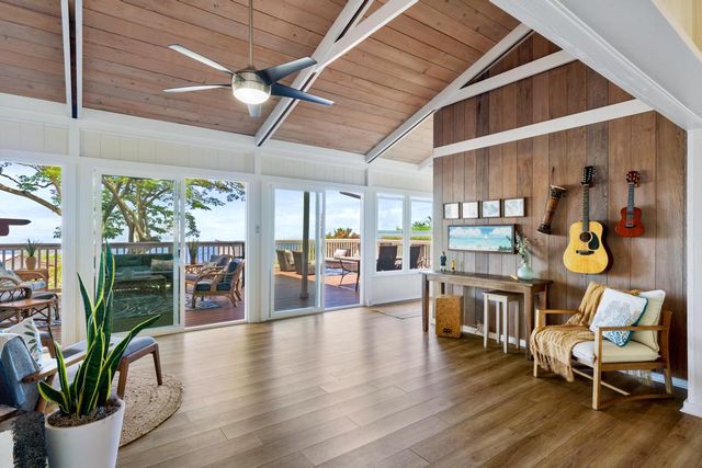 a dining room with furniture water view and wooden floor