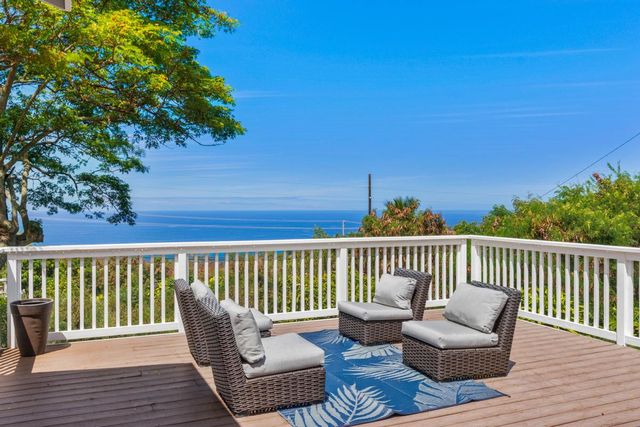 a balcony with wooden floor and fence