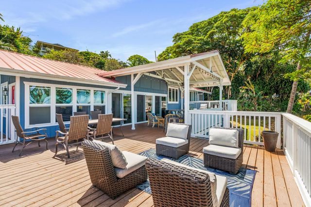 a view of a patio with couches chairs and wooden floor