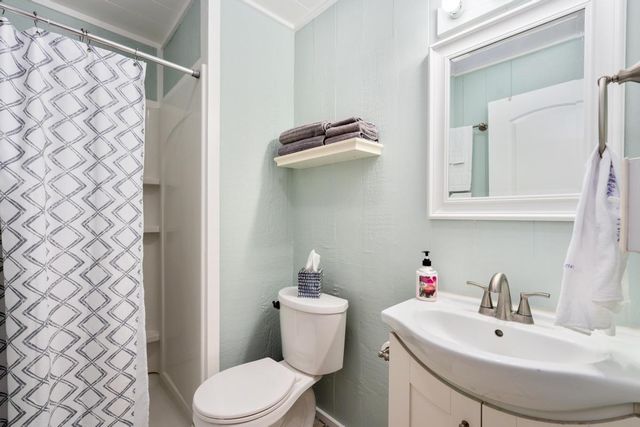 a bathroom with a sink mirror and toilet