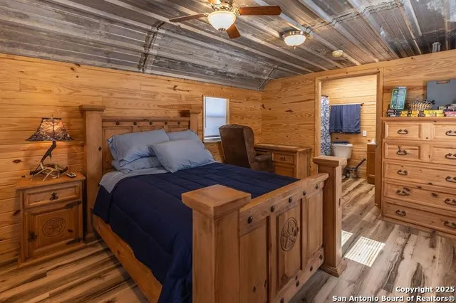 a bedroom with a bed and wooden floors