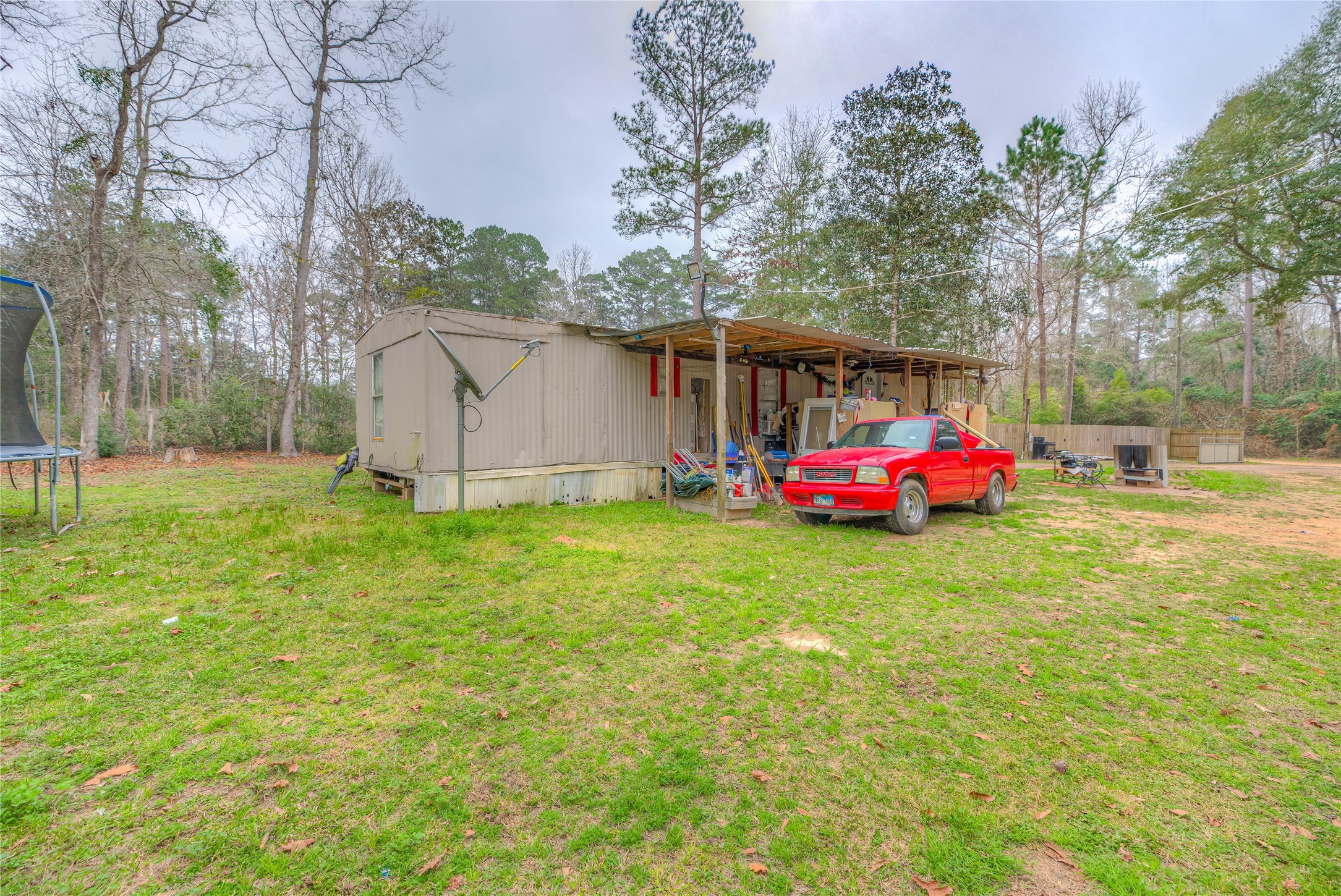 713 Garrett Road Livingston, TX 77351 - Photo 22 of 40 a backyard of a house with table and chairs
